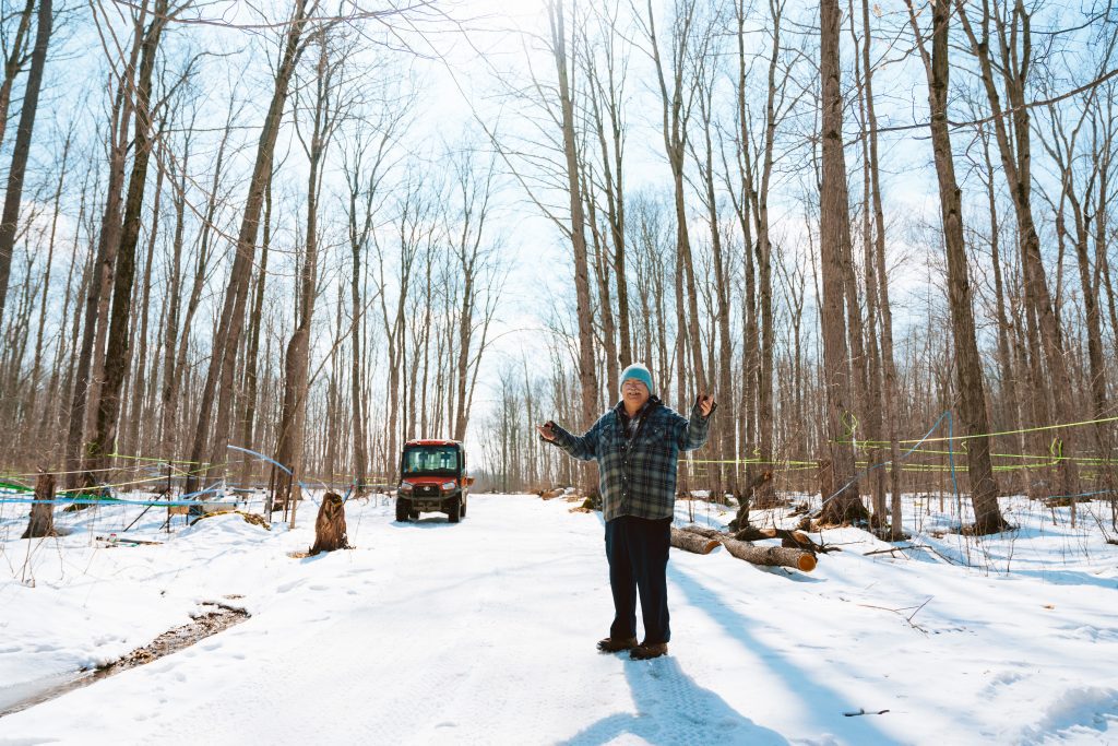man standing in the sugar bush at Hoover's Maple Farm