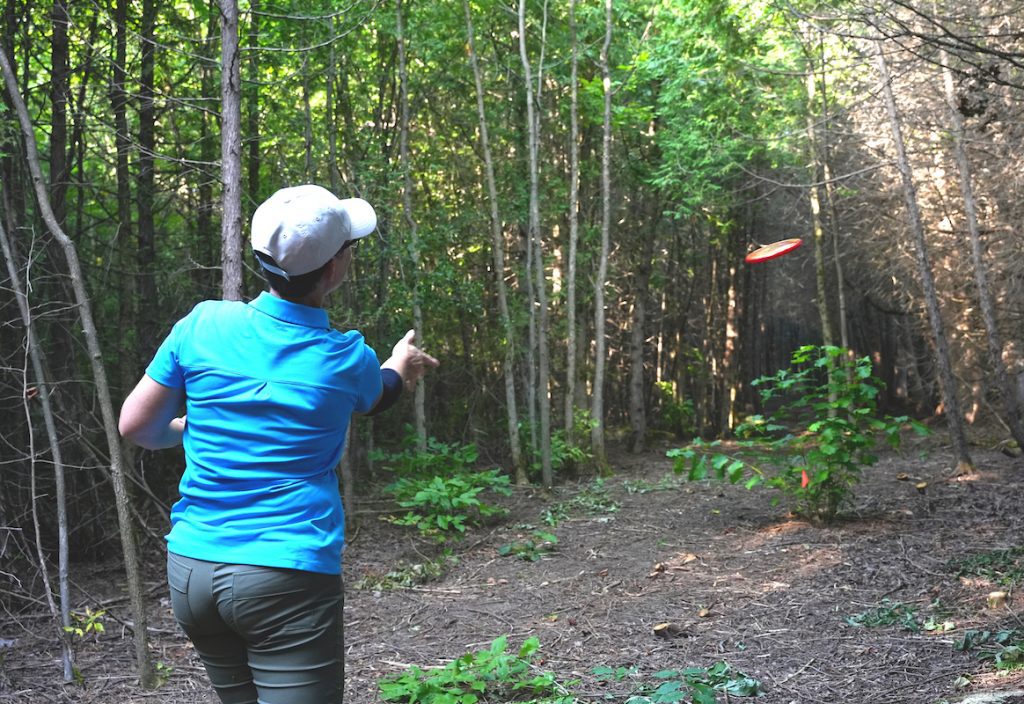 Diane, amateur disc golfer, testing out the course at Springfield Farm Organics