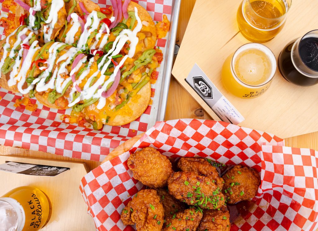 tostadas, chicken wings and flight of beer at Black Bellows Brewing, overhead shot