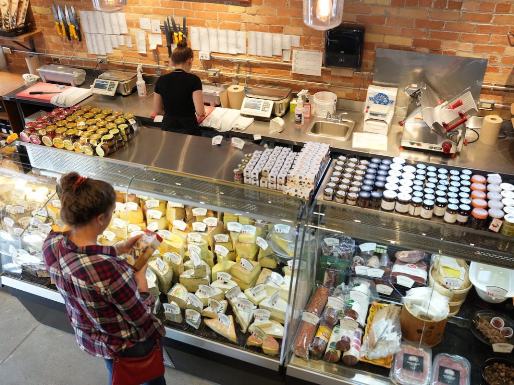 Looking down at customer shopping at the cheese counter at Dags and Willow