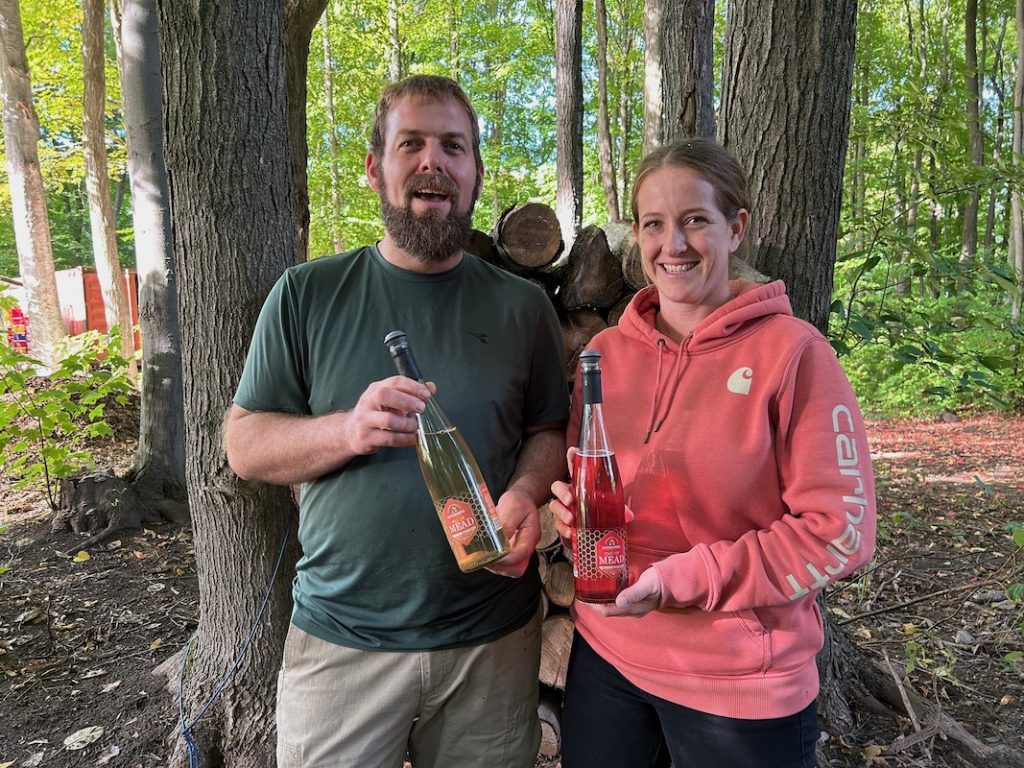 Sarah and Peter holding their mead at Ontario Honey Creations