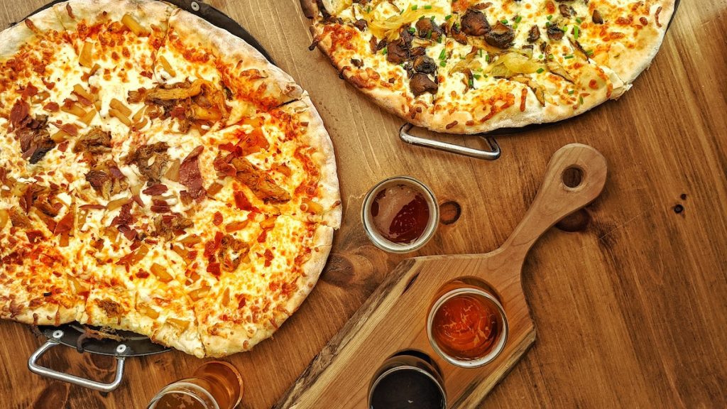 overhead shot of pizza from pie eyed monk and beer from Lindsay brewing