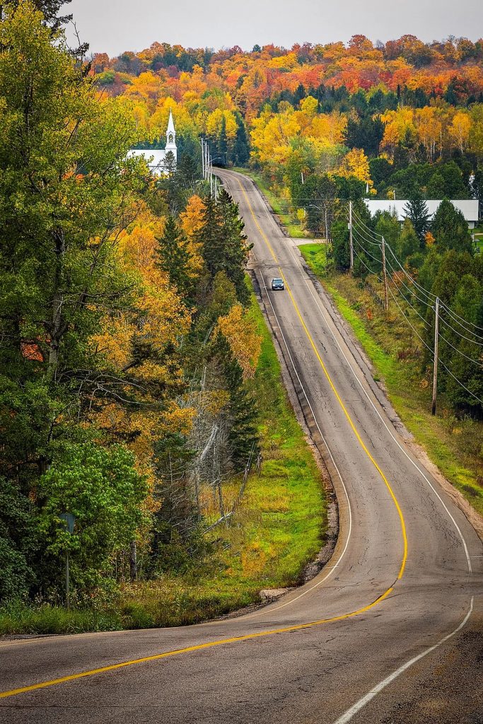gorgeous view of windy road in Ottawa Valley with the start of fall colours