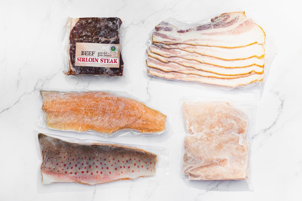 northern raised flat lay overhead shot of fish, beef and bacon
