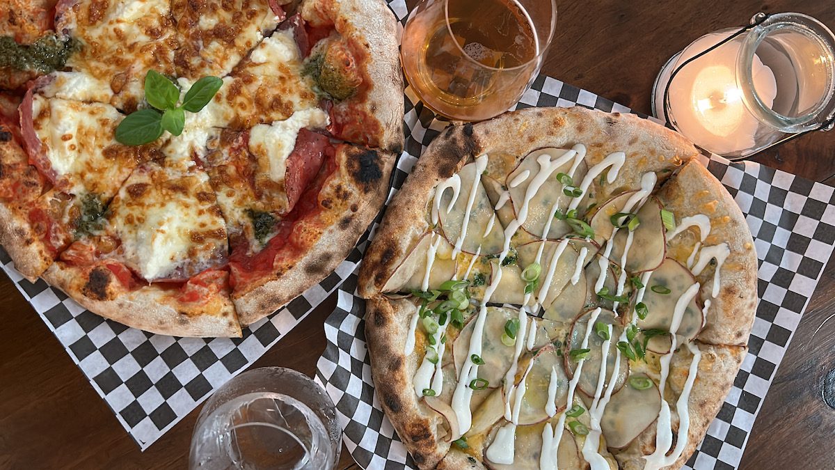 overhead shots of two pizzas, a beer and a g and t at Elgin Harvest