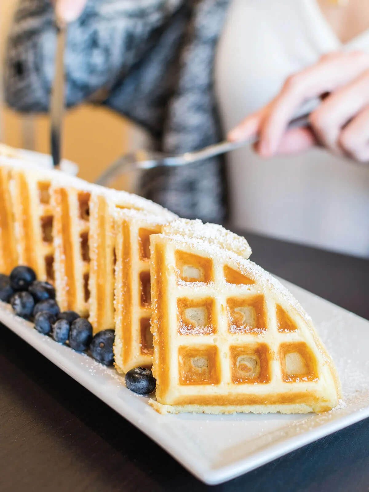 A plate of waffles with blueberries