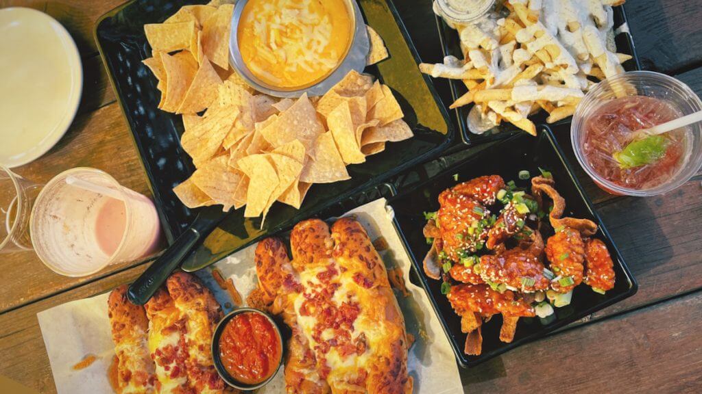 overhead shot of food at GTS including potato skins nachos and tortilla chips