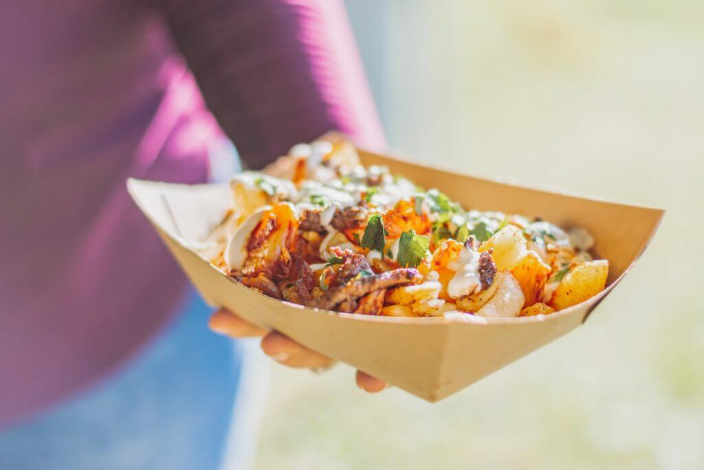 loaded potato wedges being held in a box