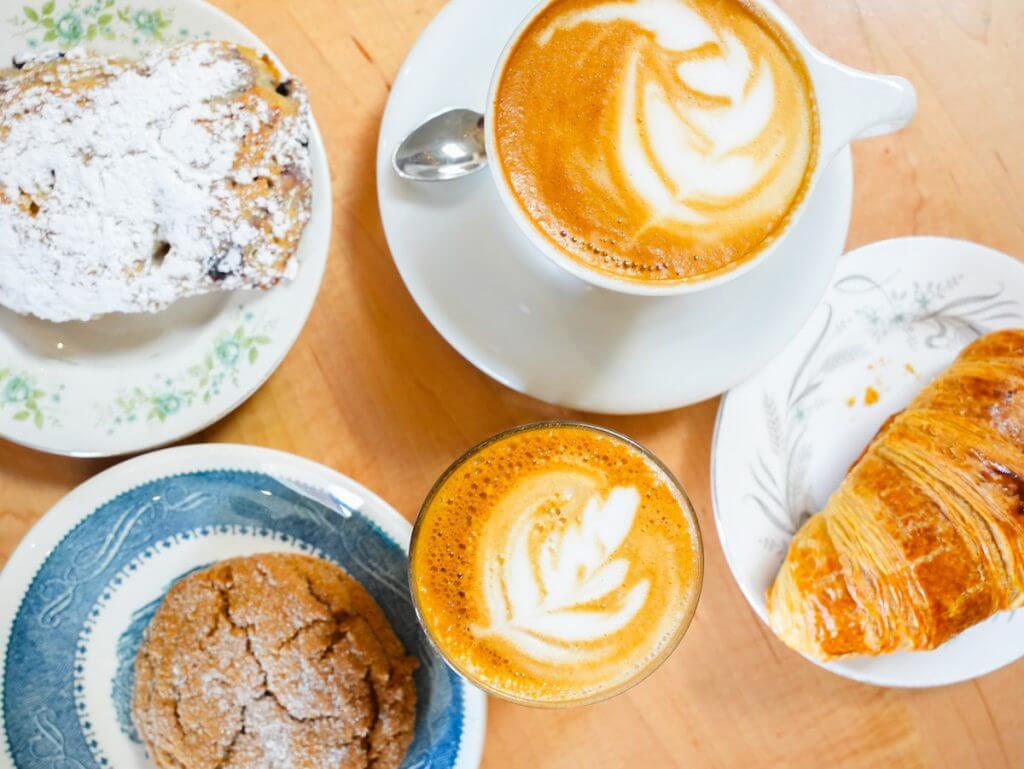 overhead shot of cappucino, cortado, croissant, ginger cookie and scone thing from Gibson and Co.