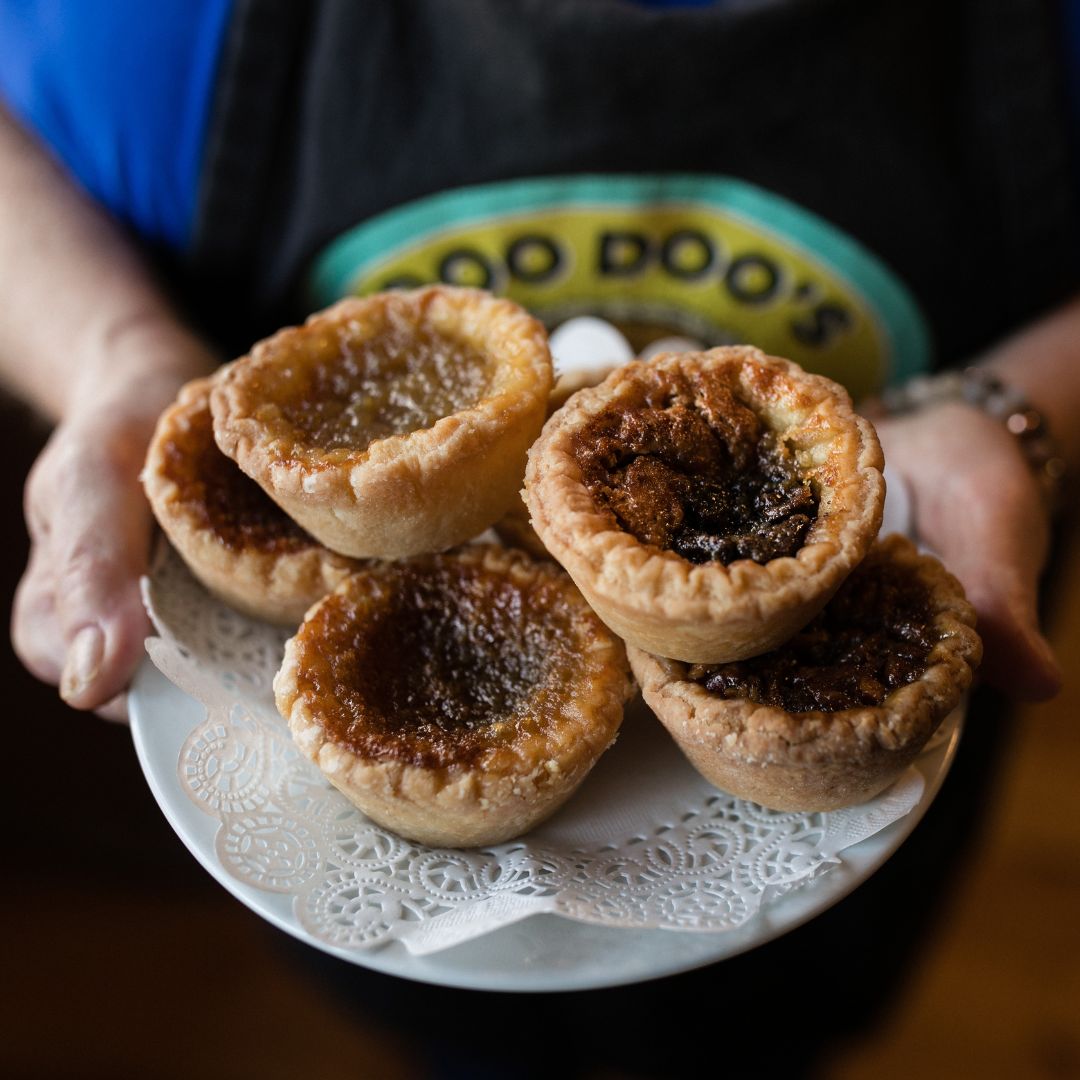 A plate of butter tarts stacked on each other
