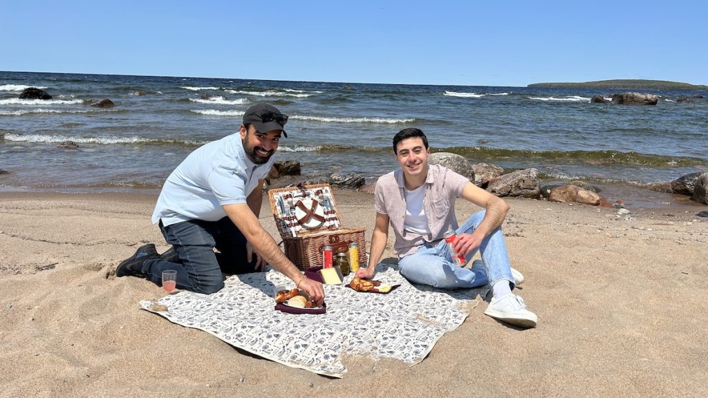 Abhigamya and Zain enjoying the Farm 2 Door picnic on the beach at Awenda Provincial Park