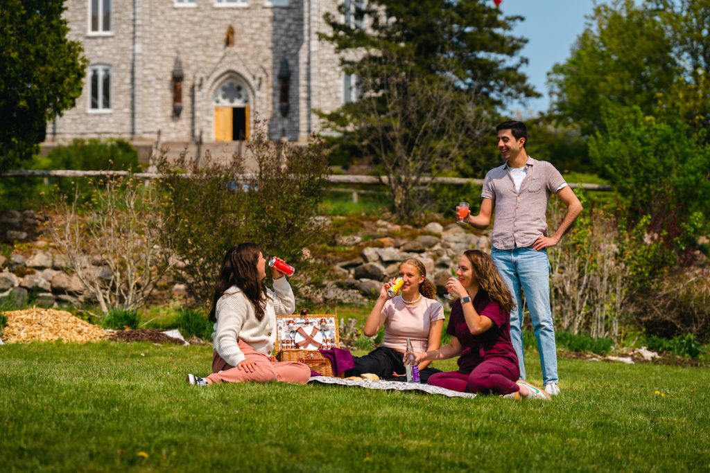 Four people enjoying a picnic out front of the Martyr's Shrine Church