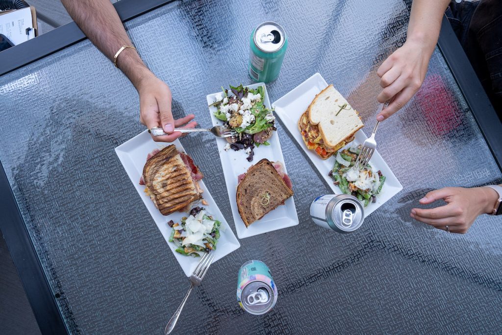 The Counter restaurant overhead shot of three sandwiches and side asparagus caesar salads