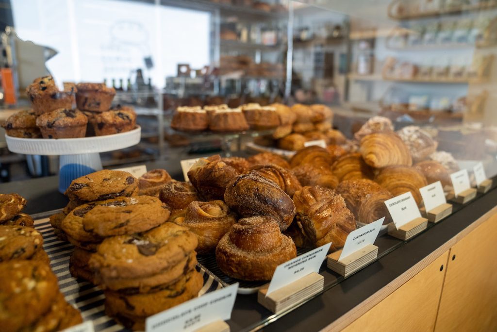 close up of the counter at small scale bread with loads of baked goods