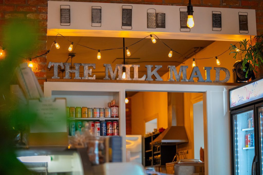 Shot of Milk Maid interior with big tin letters that read "THE MILK MAID" up on a shelf