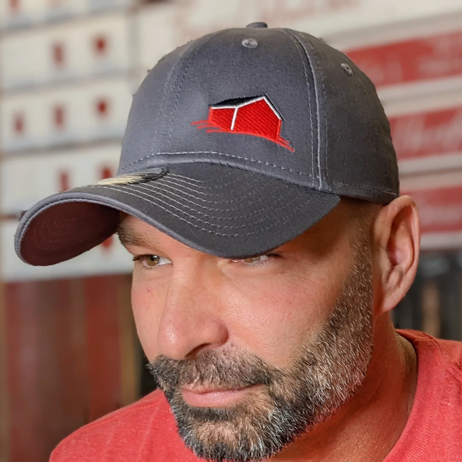 grey hat from red barn
