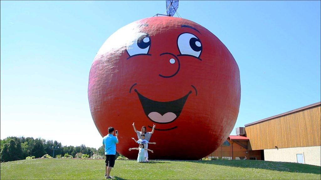 big apple and two kids running up to it
