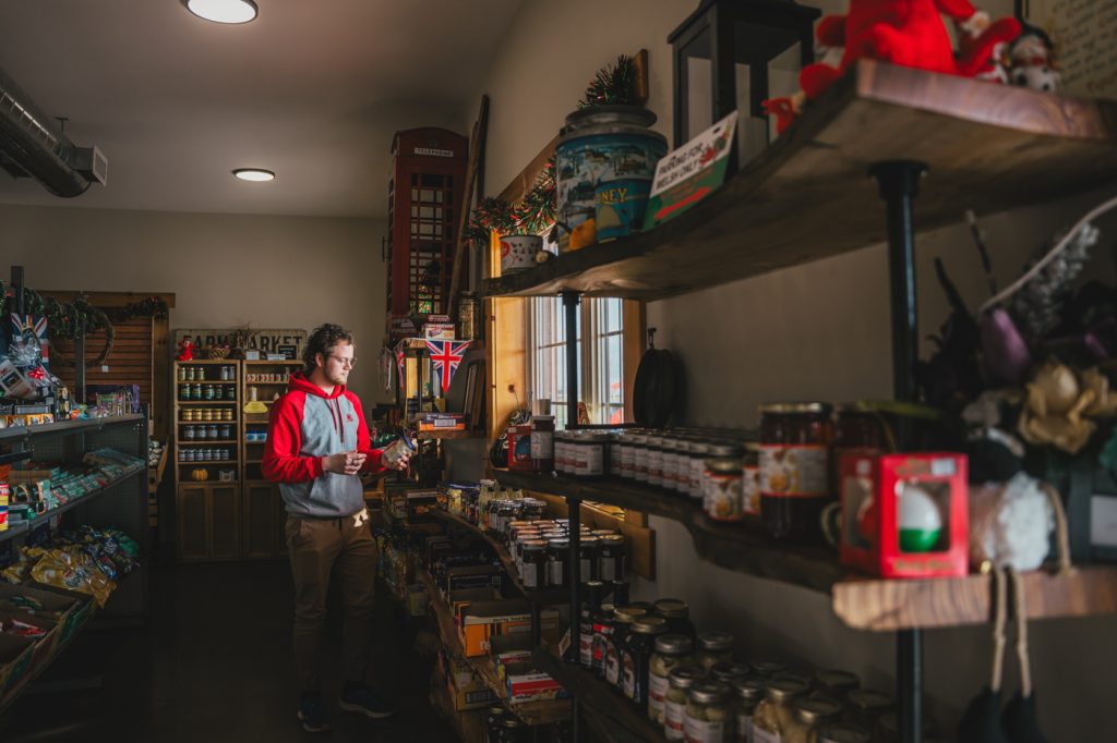Red Dragon Dairy interior with man stocking shelves
