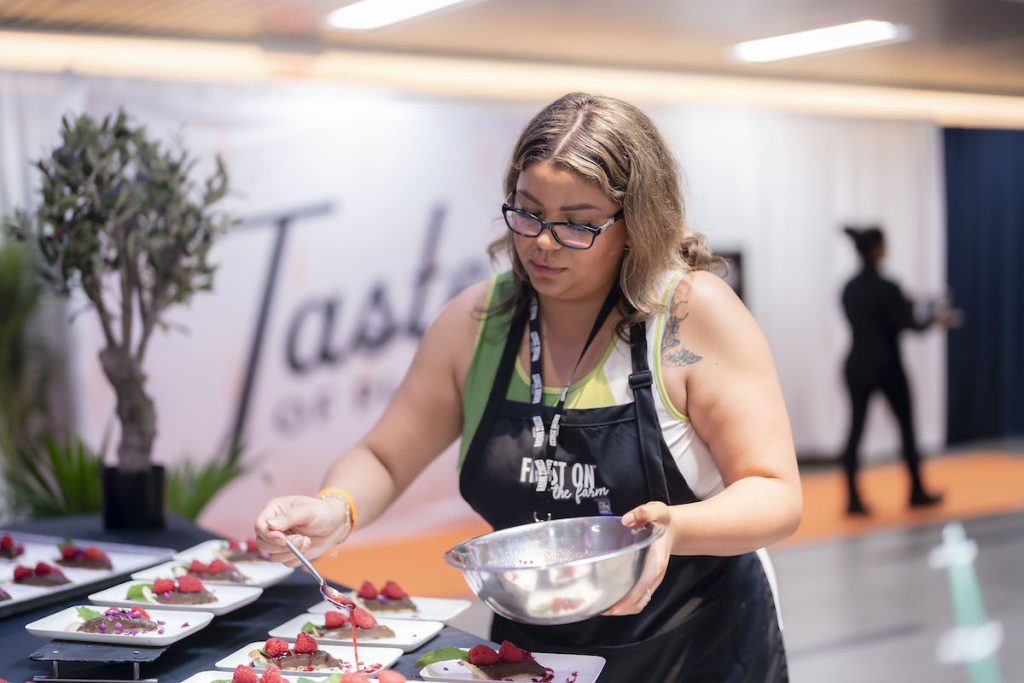 Aicha plating a chocolate raspberry pie she made at the Taste of Place Summit