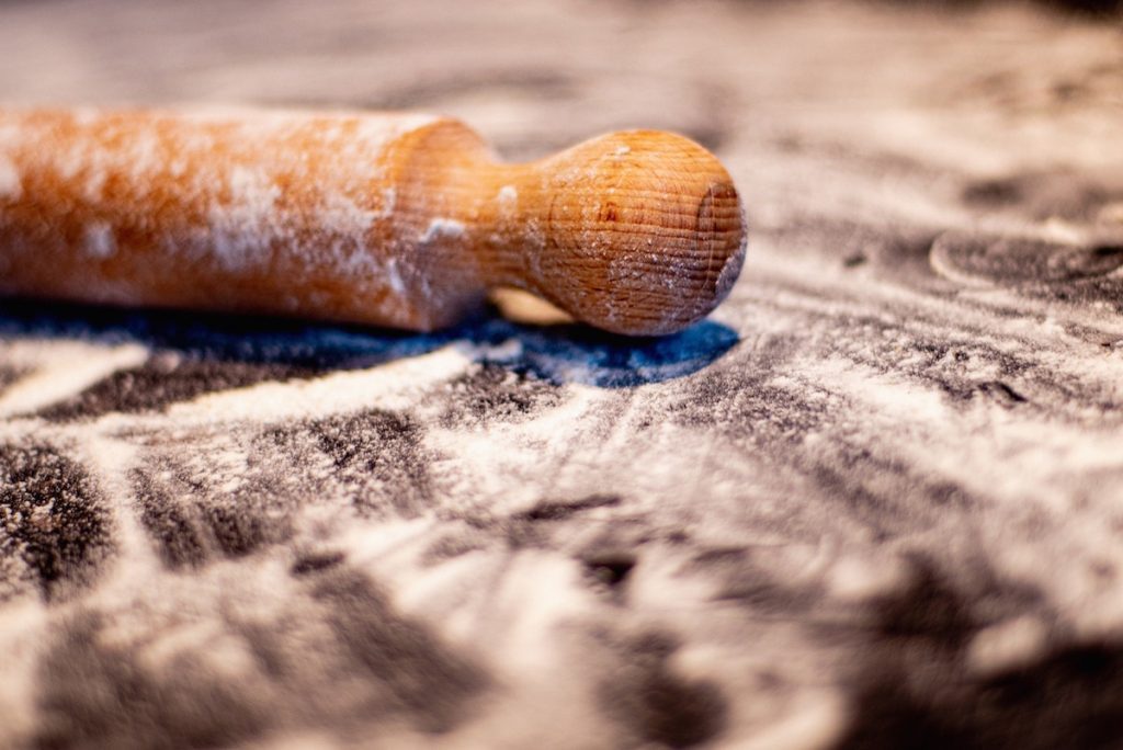 close up of a rolling pin with flour on it