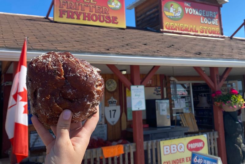 Image of apple fritter outside the voyageurs lodge building.