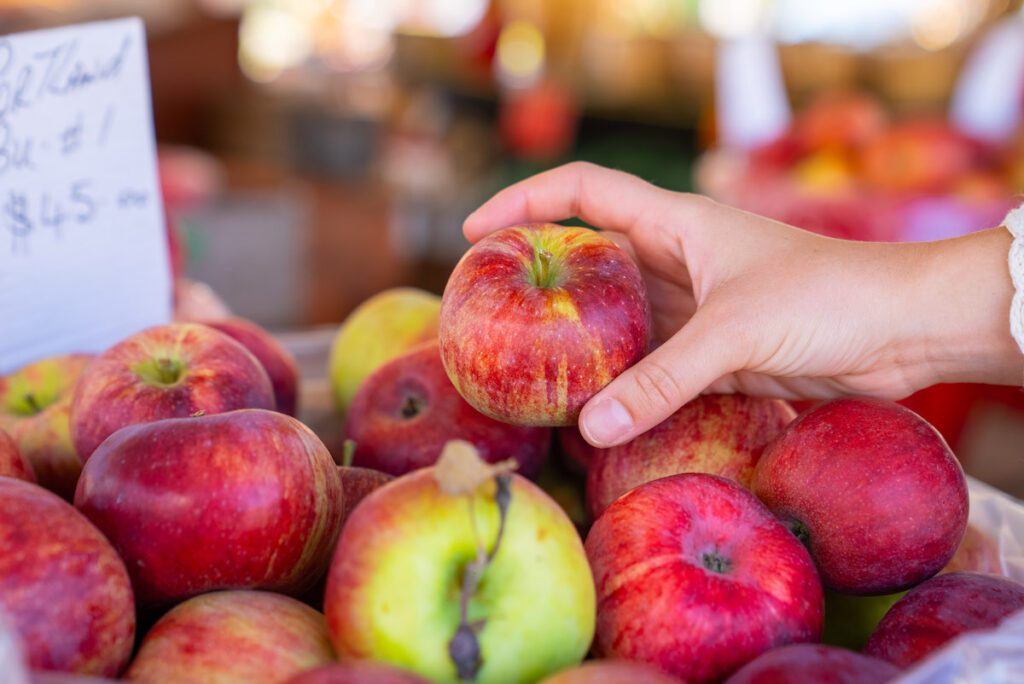 hand grabbing apples