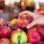 hand grabbing apples