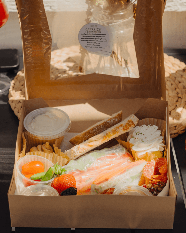 close up of snack box filled with fruit, veggies, and charcuterie meats