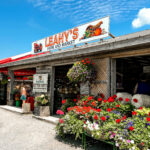 The front facae of Leahy's farm market on a sunny day with blue skies