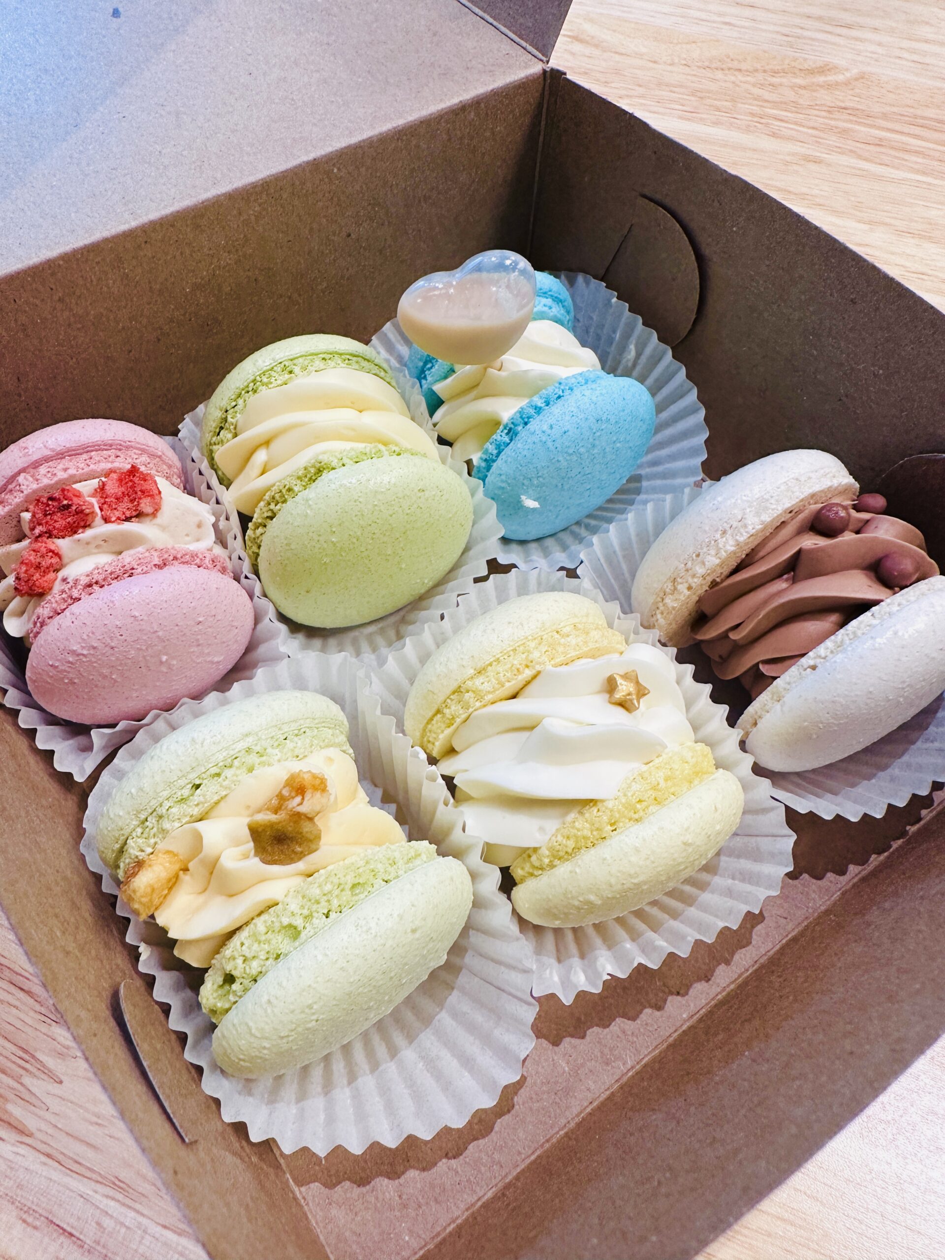 photo of a box stuffed with colourful stuffed macaron cookies