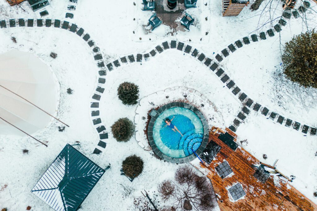 drone shot of girl laying in pool at Terra Nova