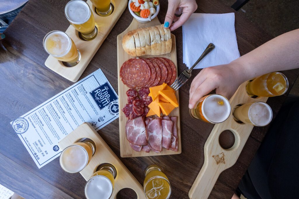 overhead shot of three flights and a charcuterie board at Northern Superior Brewing