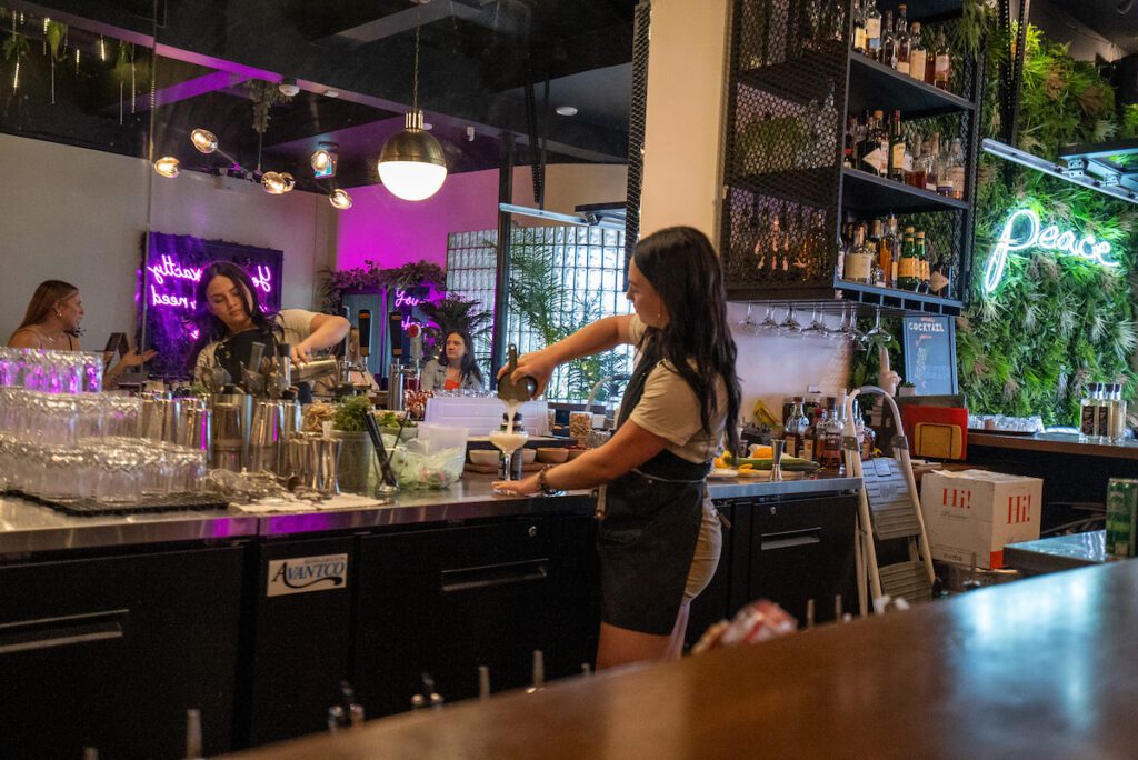 Gabrielle making a cocktail at Peace Restaurant