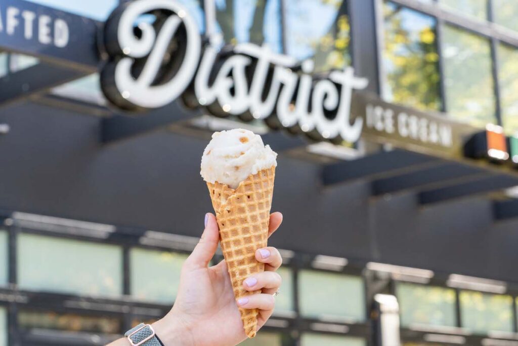 holding up a cone at District Ice Cream