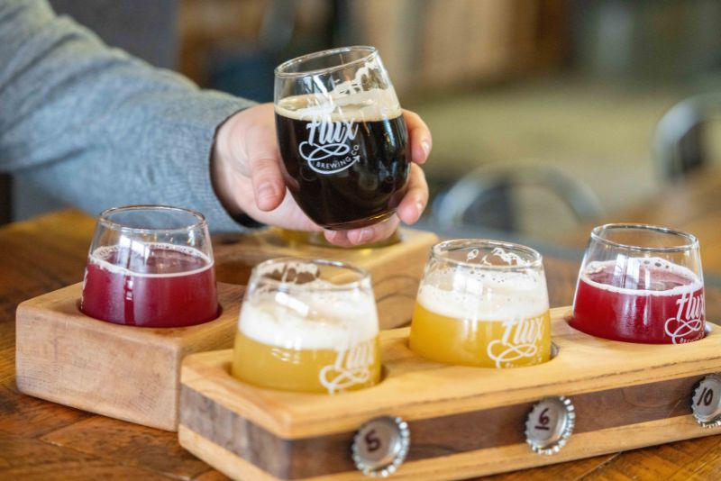 close up of beer flight with glass lifted