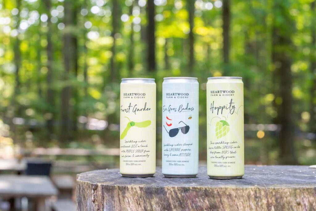 three ciders lined up on a stump at Heartwood Cider